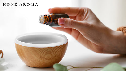 Woman adding aroma oil into a diffuser